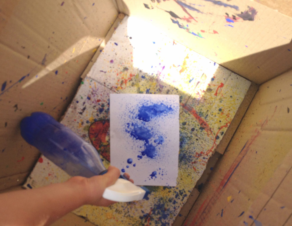 A spray painting booth made out of a cardboard box