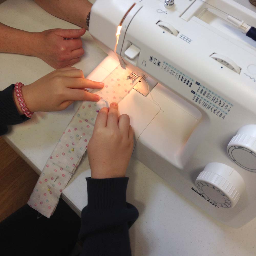 teaching children how to sew in our machine sewing classes 
